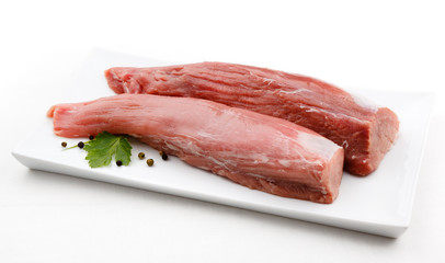 Fresh raw pork loin on white plate