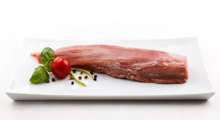 Fresh raw pork loin on white plate