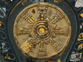 yellow stone carving with golden plate