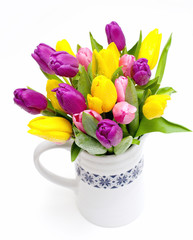 tulips with droplets in vase on white