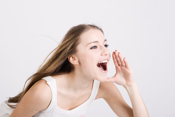 The girl shouts, having combined hands in a megaphone.