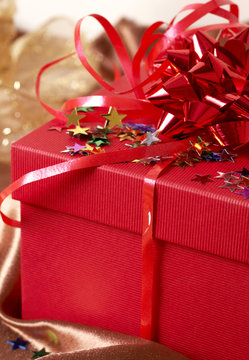 Red gift box with bows and stars