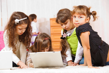 Kids sit around laptop