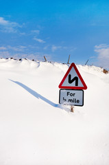 road sign in snow drift