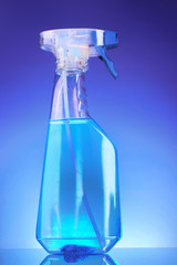 blue spray bottle on blue background