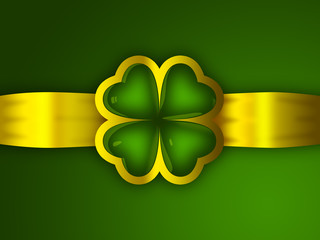 A reflective glass four leaf clover and golden ribbon