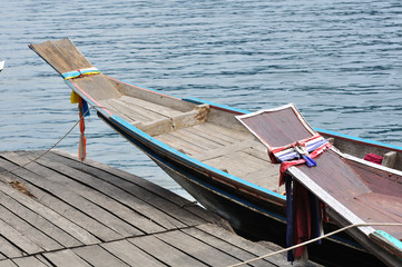 Head of two long tailed boat decorated with colorful cloth