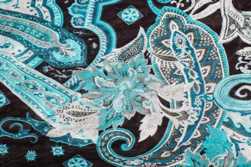 Blue oriental patterns on a scarf textile with selective focus