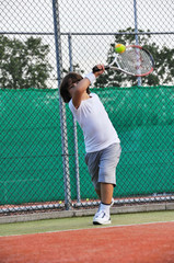 Young boy play tennis
