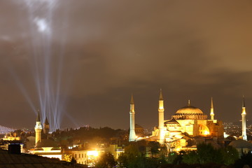 Illuminated Hagia Sophia and some beams (national holiday) in Istanbul at night