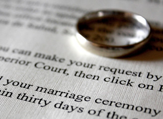 A Marriage Certificate and White Gold Wedding Ring