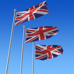 Fototapeta na wymiar Three flags of UK against blue sky.