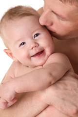 Father kissing smiling baby - parental love