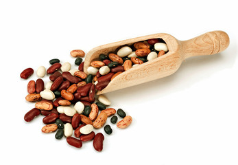 Beans with wooden scoop over white