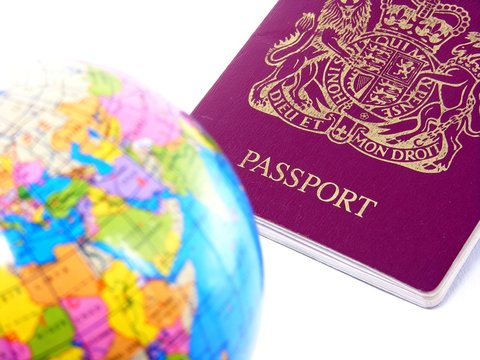 Passport & world globe on white background - DOF