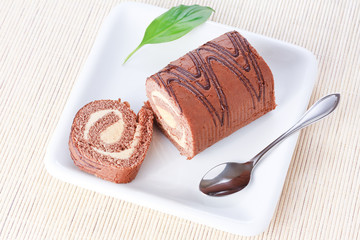 Swiss roll with condensed milk cream and a green leaf