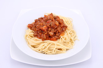 Spaghetti bolognese on a plate on a white background