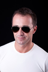 Portrait of a handsome middle-age man smiling with sunglasses