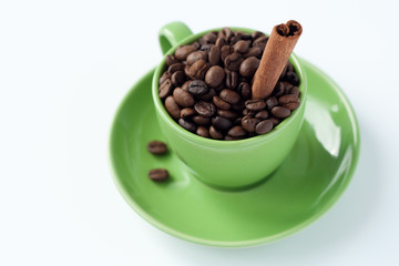 Coffee beans in a green cup