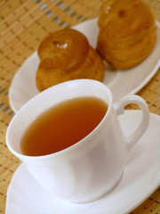 Brewing delicious cake with cream and a cup of tea