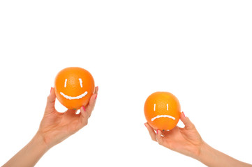 Hands hold oranges with smile and insult