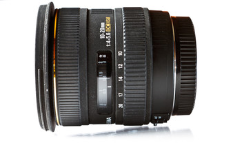 Black camera lens isolated in white background on glass