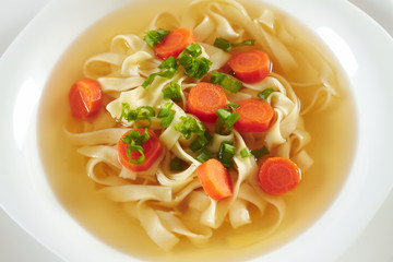 Chicken soup with macaroni and carrots , zupa