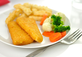 fish fillets with fried potato and vegetables,