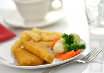 fish fillets with fried potato and vegetables,