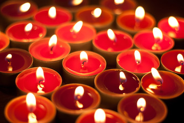 Candles burning in the dark.