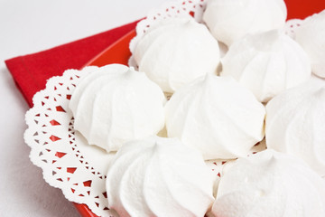 Delicious sweet meringue kiss-cake on red plate