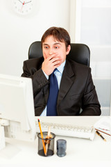Naklejka premium Shocked businessman looking at computer monitor.