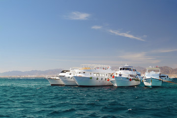 Fototapeta na wymiar Boats anchored on Red Sea coral reef