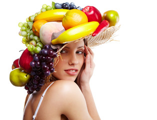 Shot of a beautiful young woman with fruits headwear. Food conce