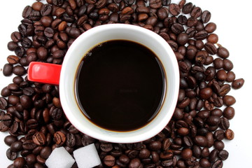 Red mug of coffee with roasted coffee beans and sugar lumps