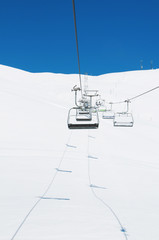 Ski lift chairs on bright winter day