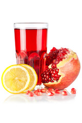 Fresh ripe pomegranate, lemon and glass of juice on white