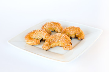 Four crosissants on white plate