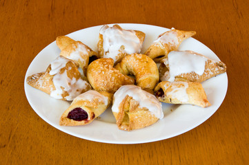 Plate of assorted pastry on wooden table