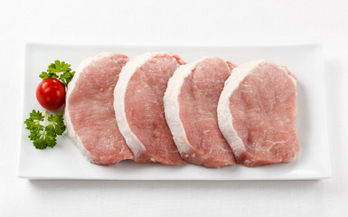 Fresh raw pork on white plate