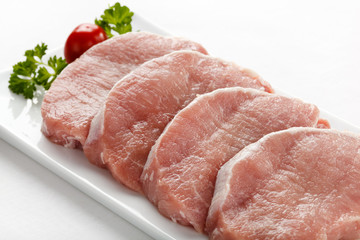 Fresh raw pork on white plate