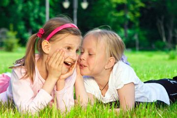 Two pretty young girls on a grass