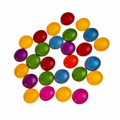 Button shaped colorful candies isolated over white background.