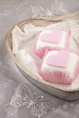 heart shaped pink cupcakes in  tin tray with gray shine backgrou