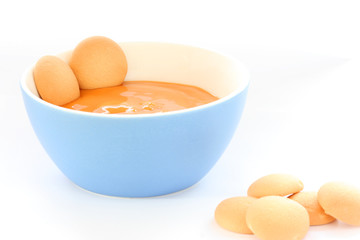 Red bowl with children fruit pap / mush with sponge-biscuits
