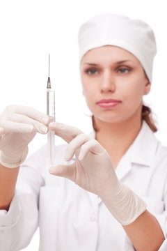 Doctor with syringe in her hands.