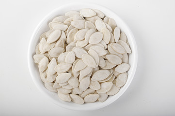 shell of pumpkin seeds on white dish