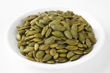 pumpkin seeds on white dish