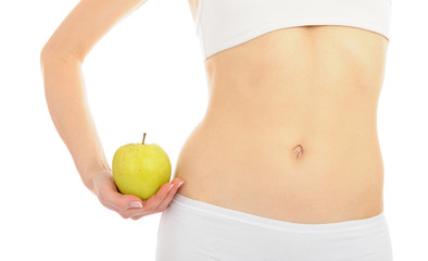 woman with beautiful body holding an apple near the slim waist. - 29735856