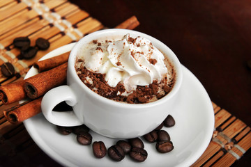 cup of coffee with cream and cinnamon